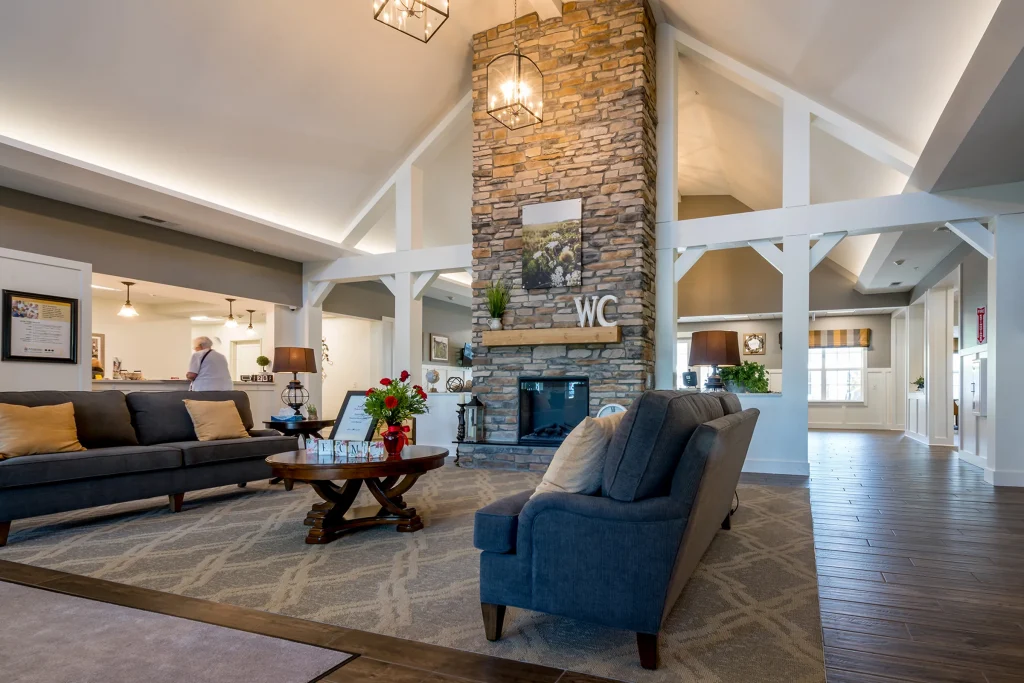 great room with fireplace and couches in senior living facility