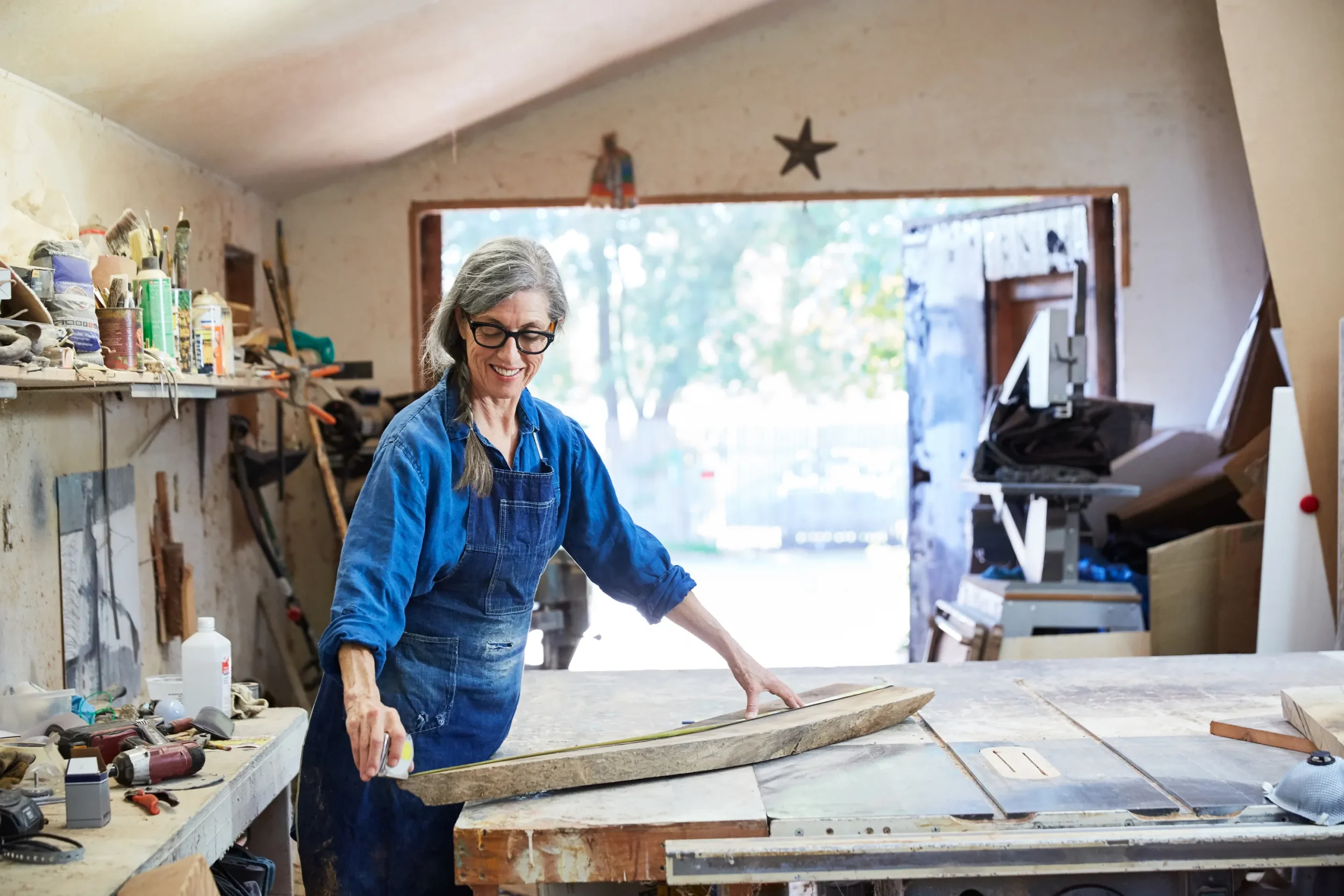 woman working with wood in makerspace