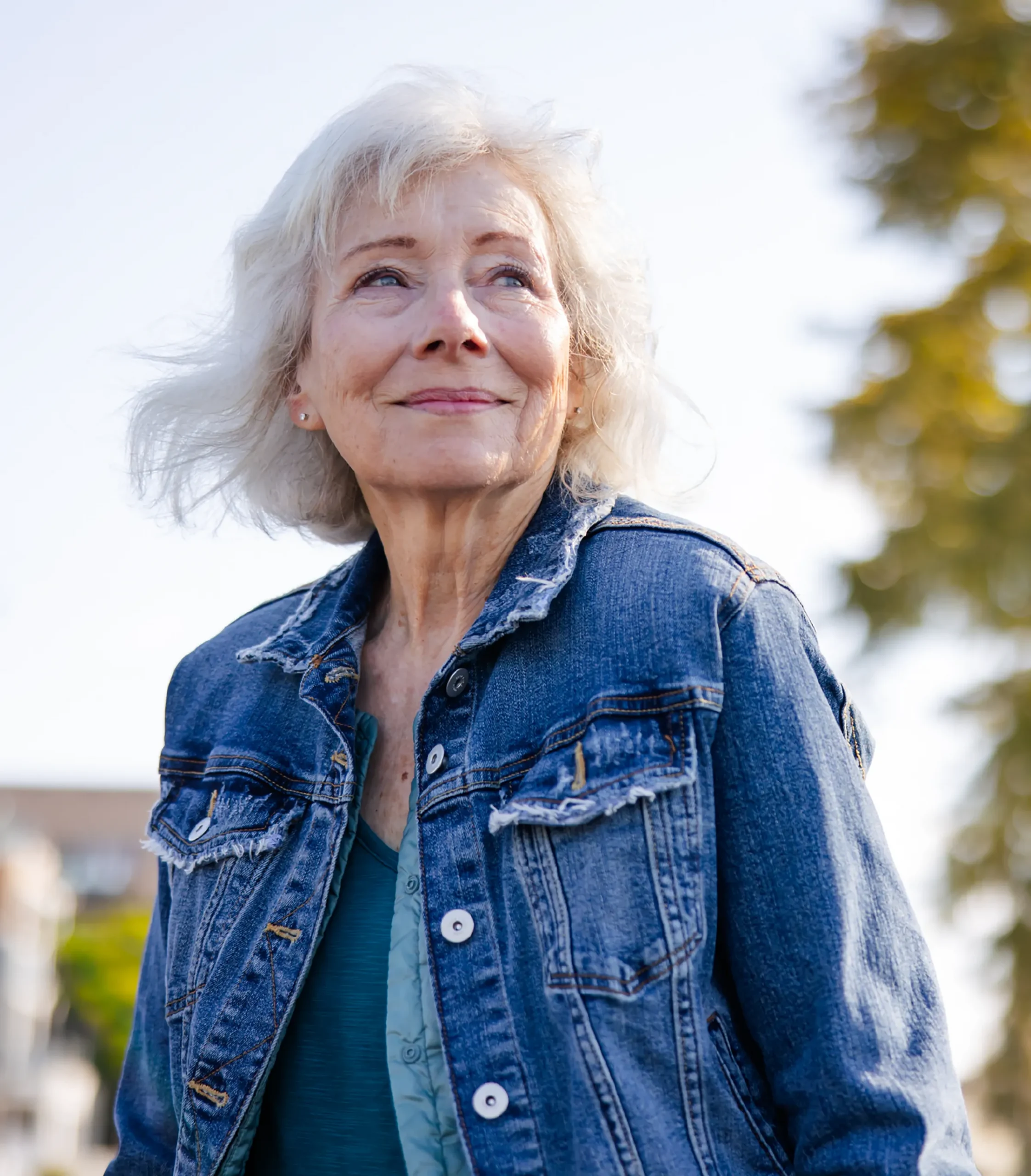 grinning woman standing outside