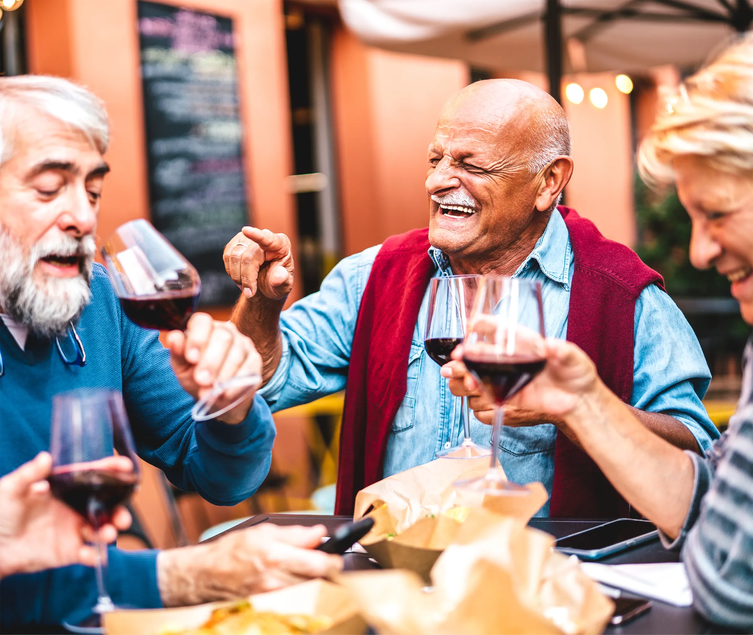 senior group enjoying red wine