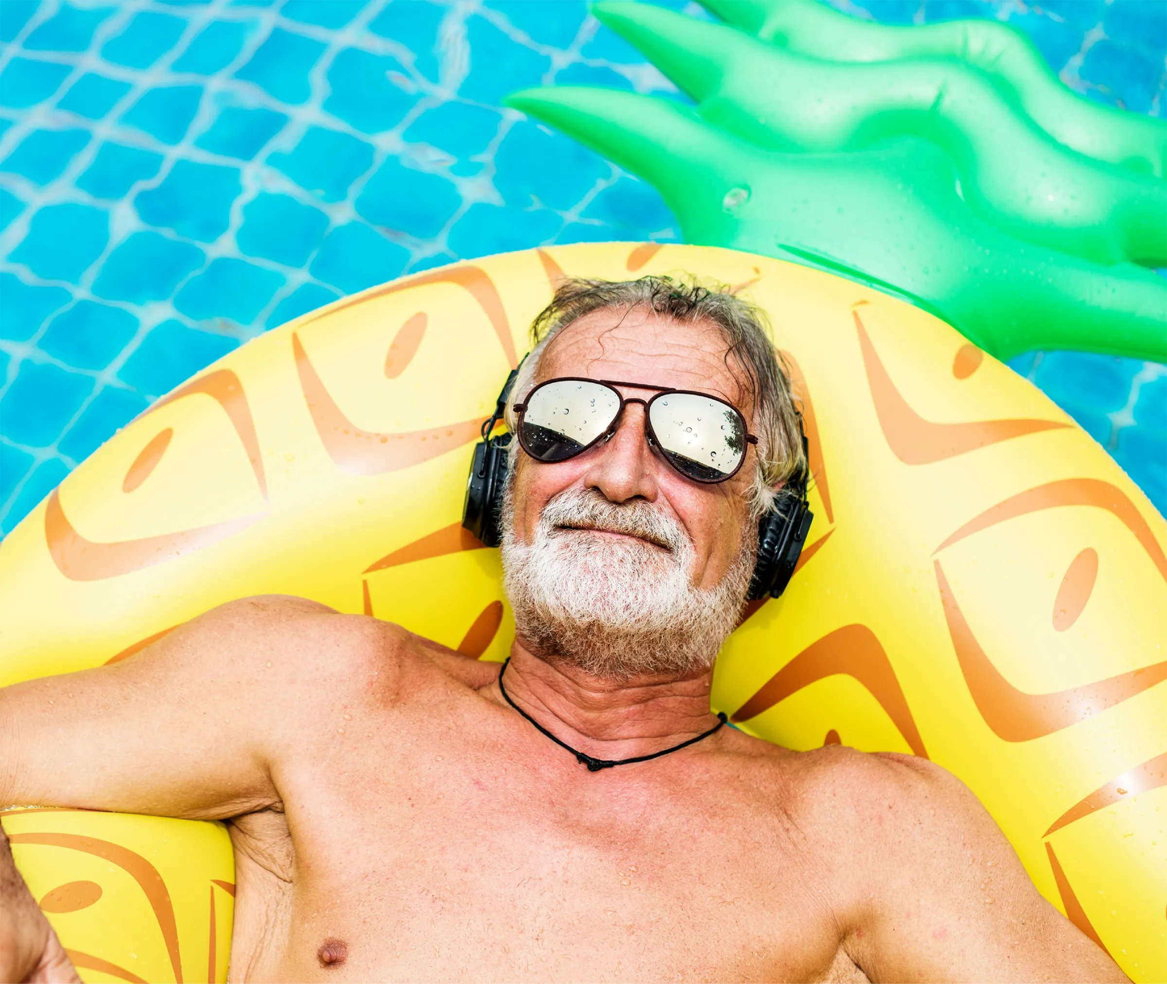 man floating on pineapple tube in pool
