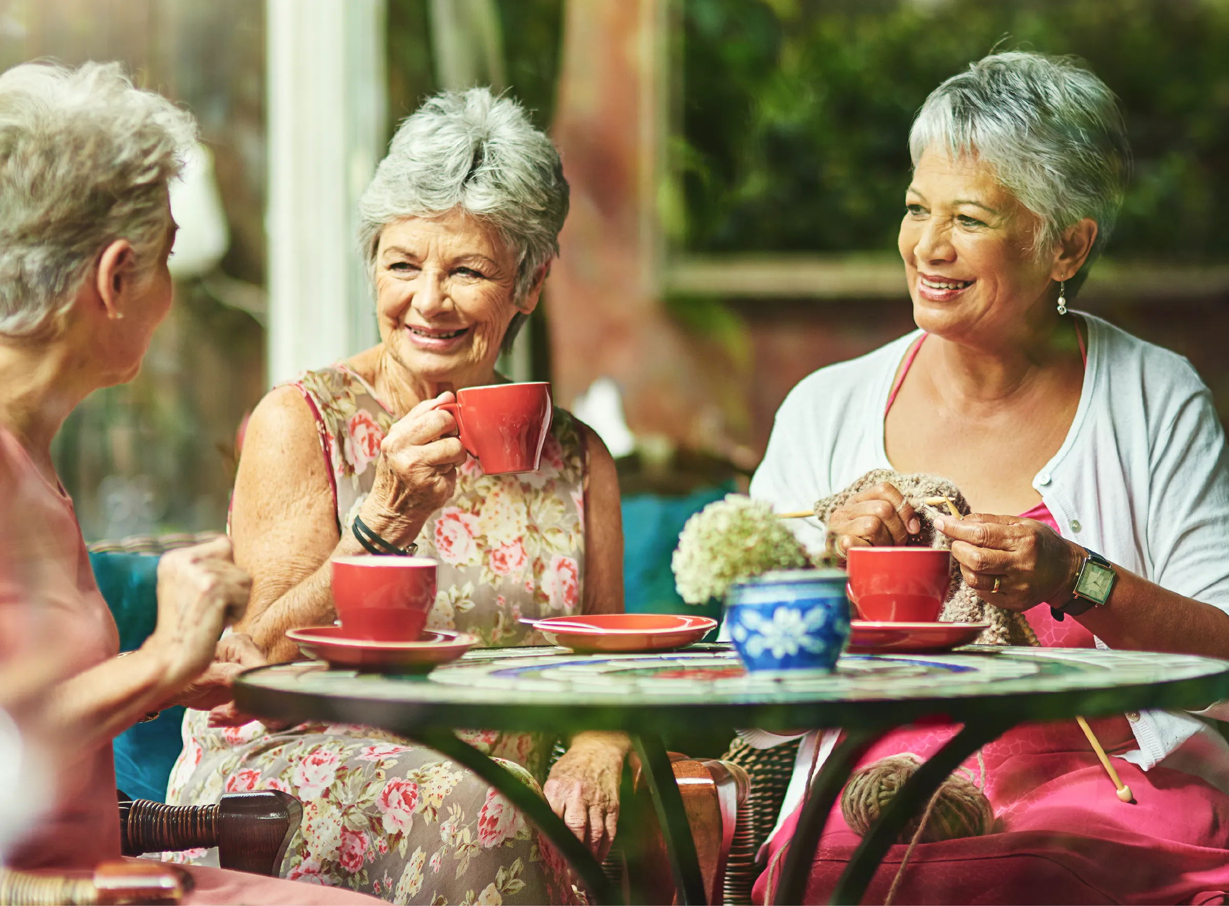 three women having coffee at an outdoor cafe