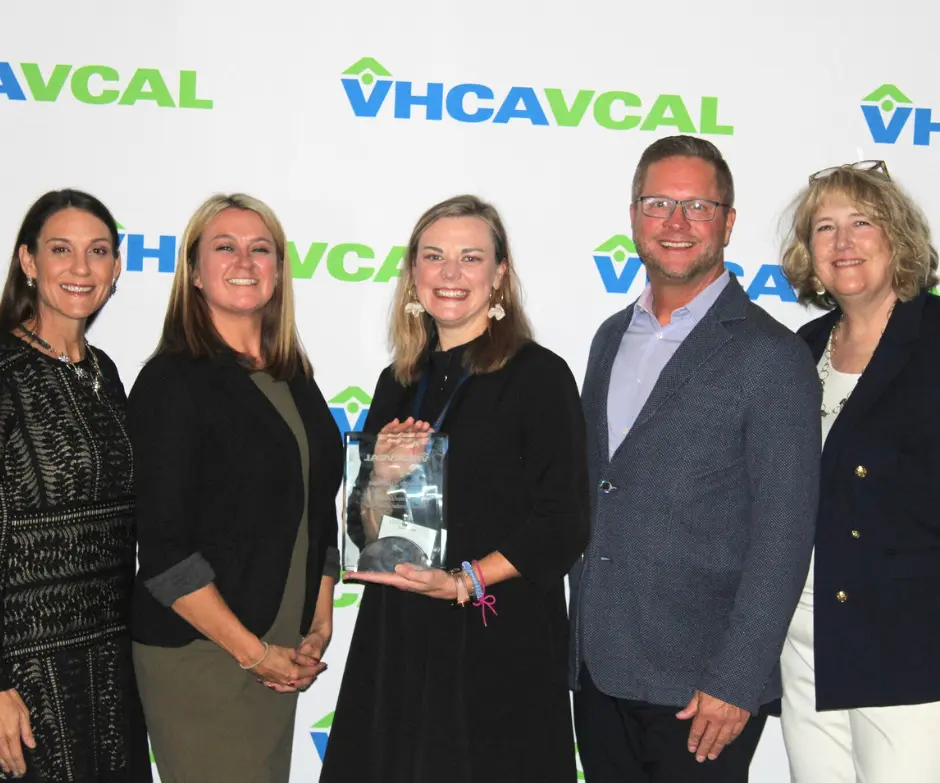 Senior living professionals posing for a photo accepting an award for best administrator in Richmond, Virginia